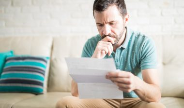 New York FDCPA man reading debt collection letter