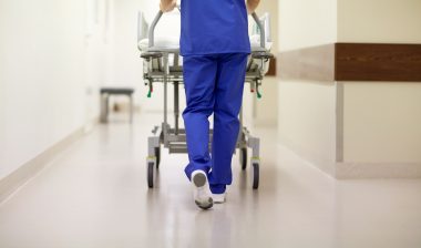 surprise medical bills hospital nurse pushing gurney