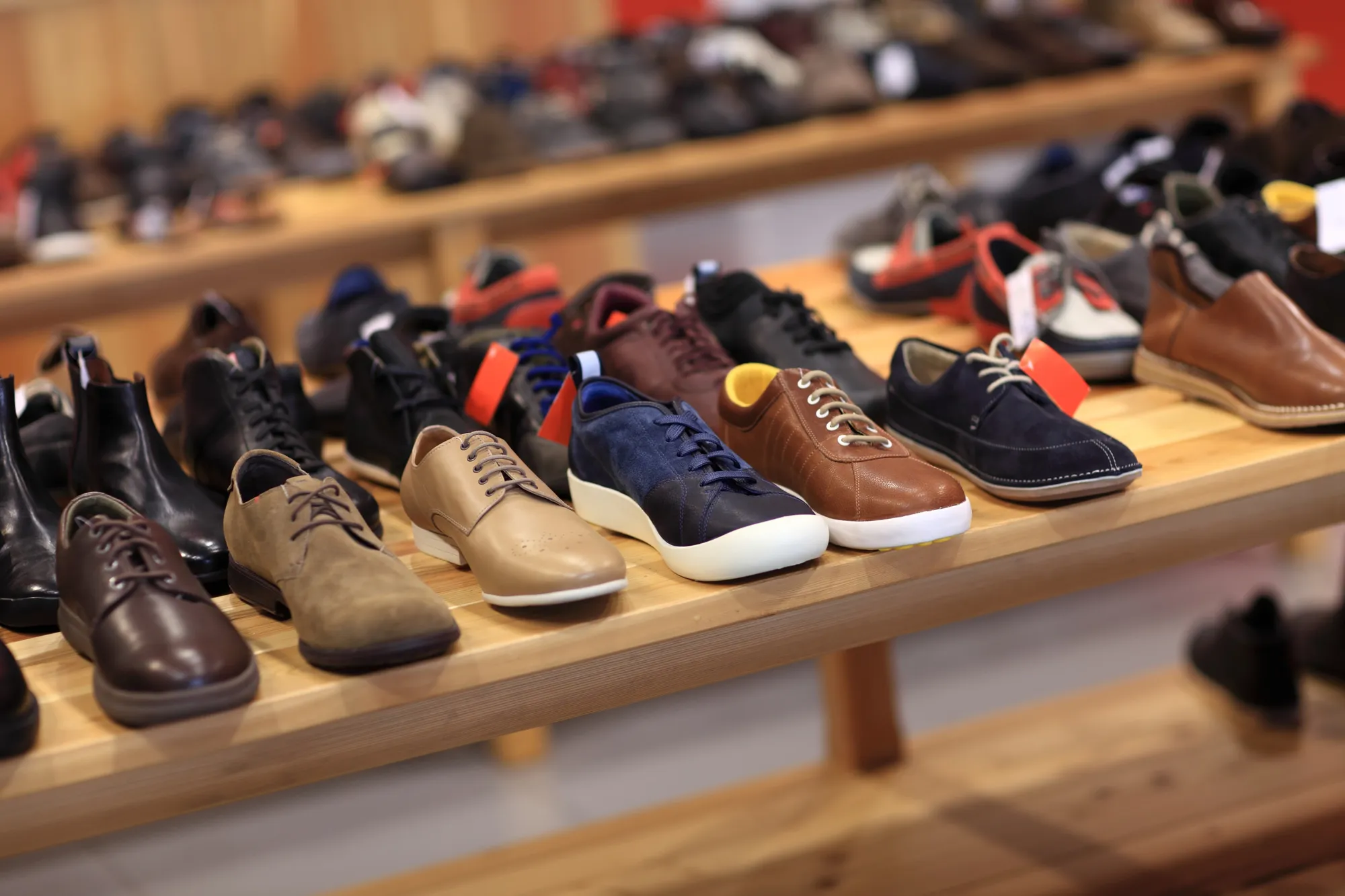Shoes on the wooden shelf in the store