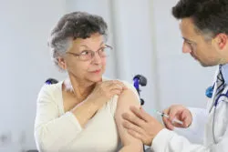 Zostavax vaccine vaccination woman getting vaccinated