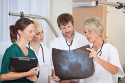 Group of doctors discussing over Xray in hospital