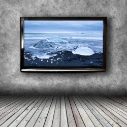 Plasma TV on the wall of the room with wooden floor