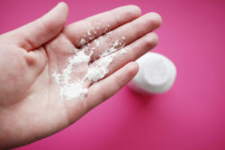 Talcum powder in woman's hand, illustrating ovarian cancer and baby powder link