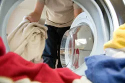 woman loading clothes into Samsung washer model