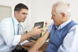 Physician giving shingles vaccine to patient