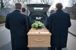 pallbearers carrying casket after wrongful death from mesothelioma verdict