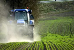 Tractor plowing farmland while Roundup cancer lawsuits are pending