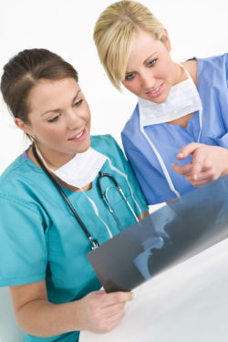 Doctors look at xray of Couple Files Pinnacle Hip Implant System