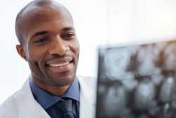 Doctor reviewing CT scan for signs of cerebellar atrophy