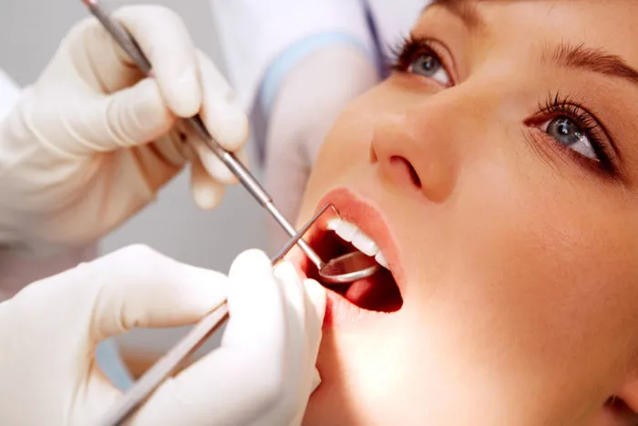 patient getting teeth examined by dentist