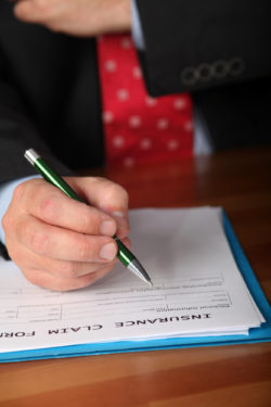 man filling out stroke disability insurance claim