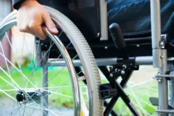 man using wheelchair after below-knee amputation