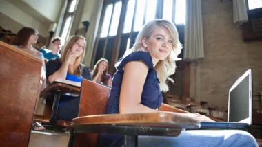 college student with laptop in WSU classroom setting