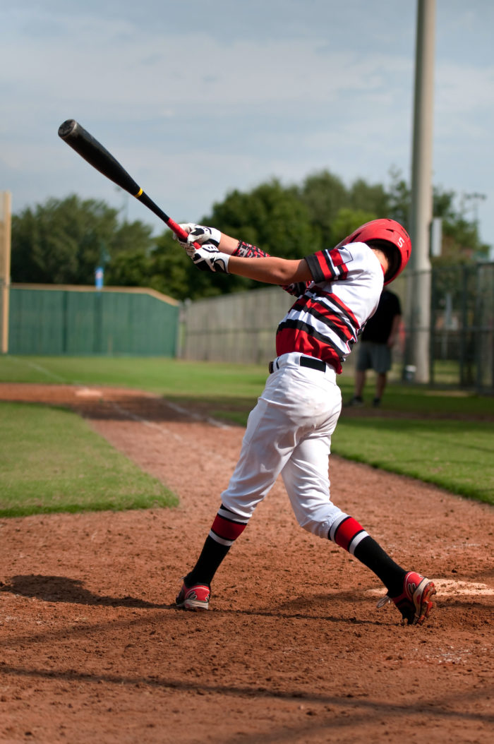 baseball player swinging bat