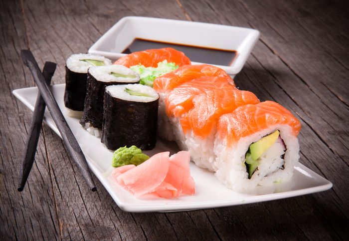 sushi salmon roll, wasabi, ginger, chopsticks