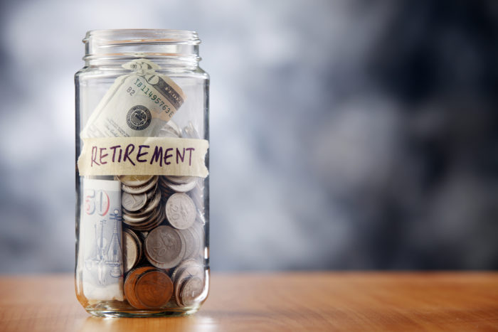 A glass jar full of money with a label that reads "retirement" - teva pharmaceuticals - wakemed - WakeMed Health and Hospitals