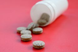 brown pills on a red background
