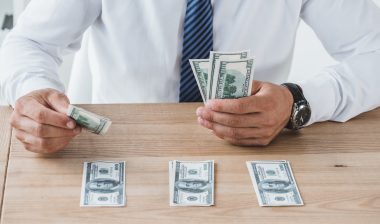 Zions Bank employee stacking money into different piles