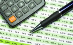 calculator and pen on a banking statement