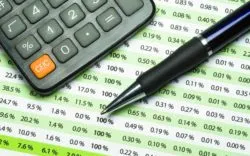 calculator and pen on a banking statement