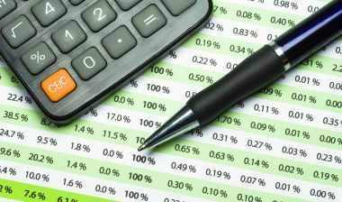 calculator and pen on a banking statement