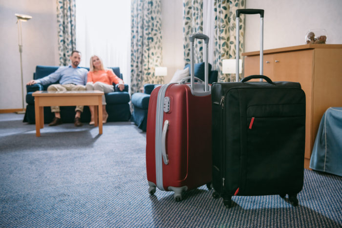 couple sitting in hotel room that they booked on Expedia