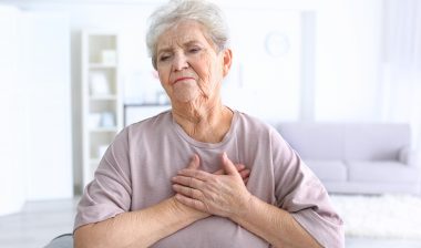 An elderly woman having a heart attack.