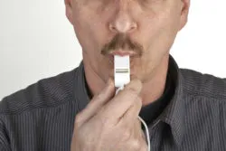 A man blowing a whistle.
