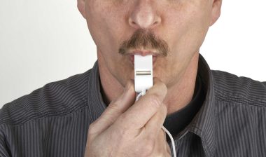 A man blowing a whistle.