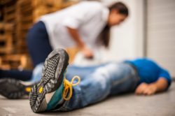 man on floor that has fallen in workplace accident