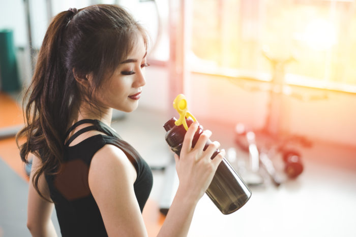 woman drinking premier protein shake