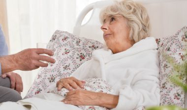 An ill woman in bed.