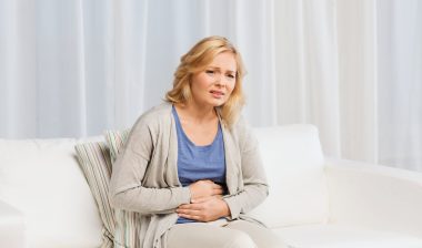 woman in pain holding stomach