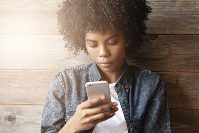 woman receiving text from debt collector