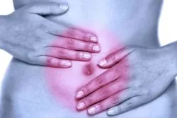 Woman in pain with hands on abdoment