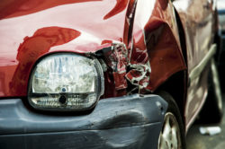 Front of a red car with body damage