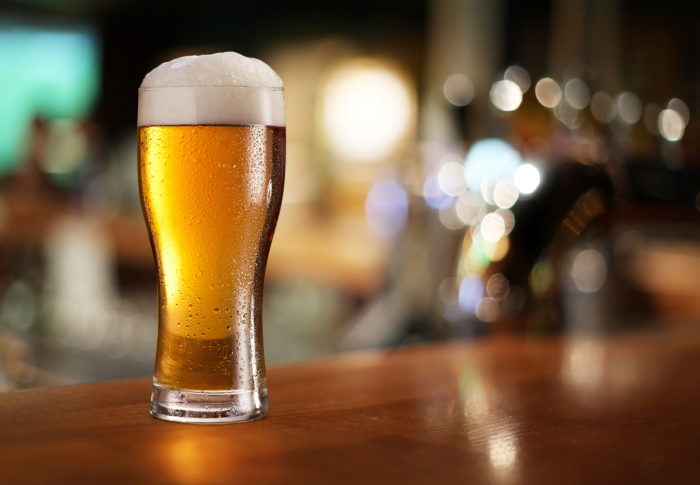 a glass of Asahi Beer with a foam top