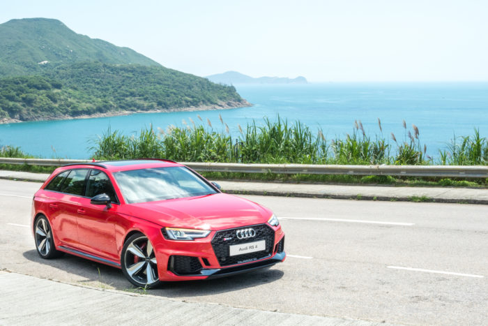 audi vehicle on a road near the ocean