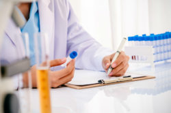 A lab tech examines a blood sample.