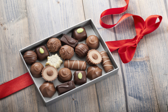 an opened chocolate box made by Ghirardelli and Russell Stover brands