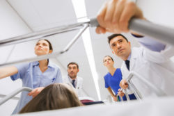 Emergency room doctors push a gurney.