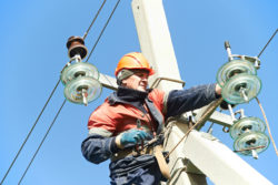 An electrician is working on power lines.