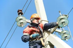 An electrician is working on power lines.