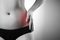 Female hip pain in black and white