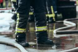 firefighters and hoses cleaning up accident