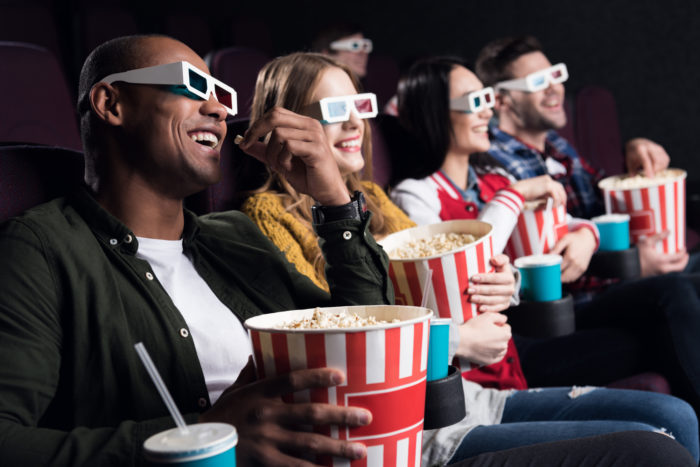 friends using moviepass to watch a movie at the theater