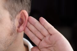 mans hand by ear