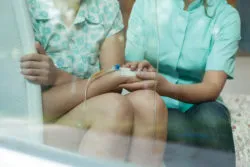 two people holding hands during chemotherapy