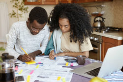A man and woman look at financial papers.
