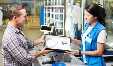 A man buying a shirt at a checkout counter